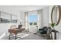 Bright study featuring a large window, a stylish desk and seating area at 17468 Whiskey Creek Trl, Parrish, FL 34219