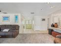 Spacious living room with carpet, tile flooring, recessed lighting, and a comfortable brown sofa at 2717 Warwick Ter, Palm Harbor, FL 34685