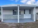 A view of the covered front porch that provides ample shade and curb appeal at 3641 Dickens Dr, Holiday, FL 34691