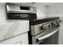 Close up of kitchen oven with quartz countertops and white cabinets and subway tile backsplash at 4036 Cortez Dr # A, Tampa, FL 33614