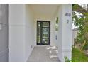 Close up of a modern black front door with glass panels and white door trim at 418 W Frances Ave # 1, Tampa, FL 33602