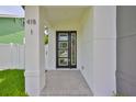 Modern glass front door with white pillars and pavers leading to the door at 418 W Frances Ave # 2, Tampa, FL 33602