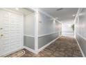 Inviting hallway featuring neutral colors, carpet flooring, and well-lit entrance to unit 438 at 438 Mariner Dr, Tarpon Springs, FL 34689
