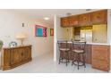 Kitchen area featuring bar seating, bright lighting, and a view of the adjacent living area at 438 Mariner Dr, Tarpon Springs, FL 34689