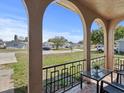 Covered front porch showing neighborhood views, complete with chairs and a table for relaxing at 5117 School Rd, New Port Richey, FL 34653