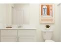 Stylish bathroom with a modern vanity, framed mirror, and decorative wall art at 9344 Bonita Mar Dr, Parrish, FL 34219