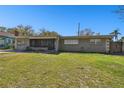 Charming single-story home with a well-maintained lawn and mature trees at 200 W Louisiana Ave, Tampa, FL 33603