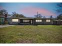 A single-story home with a well-maintained lawn at dusk at 200 W Louisiana Ave, Tampa, FL 33603