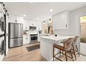 Beautifully renovated kitchen with white cabinets, stainless steel appliances, and breakfast bar seating at 10607 Carrollbrook Way # 10607, Tampa, FL 33618