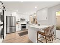 Modern kitchen featuring white cabinetry, stainless steel appliances, and a stylish breakfast bar at 10607 Carrollbrook Way # 10607, Tampa, FL 33618