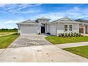 Charming single-story home with a paved driveway, well-manicured lawn, and inviting double-door entryway at 10714 Torchwood Sea Way, San Antonio, FL 33576