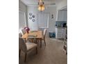 Bright dining area with a ceiling fan, window, dining table, and four upholstered chairs at 11251 80Th Ave # 210, Seminole, FL 33772