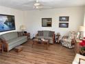 Cozy living room with a ceiling fan, sofas, chairs, a coffee table, and an area rug at 11251 80Th Ave # 210, Seminole, FL 33772
