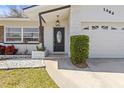 Inviting front entry featuring a decorative front door and well-maintained landscaping at 1464 S Evergreen Ave, Clearwater, FL 33756