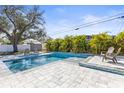 Beautiful in-ground pool surrounded by lush landscaping and a spacious patio area at 1464 S Evergreen Ave, Clearwater, FL 33756