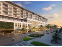 Elegant building exterior with pedestrian plaza and lush landscaping near parking at 15000 Madeira Way # 518, Madeira Beach, FL 33708