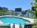 Relaxing pool area with views of waterfront marina and nearby condos at 1616 Sand Key Estates Ct, Clearwater Beach, FL 33767