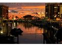 Waterfront marina with golden sunset reflecting on the water and buildings at 1616 Sand Key Estates Ct, Clearwater Beach, FL 33767