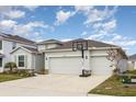 A one-story home featuring a two-car garage, well-maintained landscaping, and a basketball hoop at 18019 Fattoria Ter, Bradenton, FL 34211