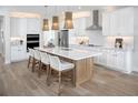 Bright kitchen boasts an island with seating, modern appliances, and pendant lighting at 18585 Watercolor Ave, Venice, FL 34293