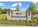 Community entrance sign with landscaping and marketing banners at 2007 Wild Heron Ct, Valrico, FL 33596