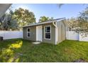 Exterior view of the house showing the siding, door and windows in the backyard at 226 W North St, Tampa, FL 33604