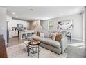 Bright, open-concept living space with a modern kitchen, dining area, and comfortable seating at 2710 Chestnut Creek Pl, Brandon, FL 33510