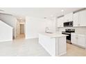 Bright eat-in kitchen featuring an island, stainless steel appliances, and white cabinetry at 31640 Malbec Dr, Brooksville, FL 34602