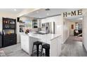 Bright kitchen with stainless steel appliances and island with bar stool seating and modern finishes at 343 37Th Ne Ave, St Petersburg, FL 33704