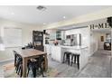 Modern open-concept kitchen with stainless steel appliances and center island, seamlessly connected to dining area at 343 37Th Ne Ave, St Petersburg, FL 33704