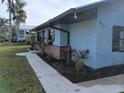 Street view of charming home with rock facade, flower boxes, and metal roof at 402 Mary St, Punta Gorda, FL 33950