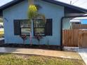Street view of charming home with rock facade, flower boxes, and metal roof at 402 Mary St, Punta Gorda, FL 33950