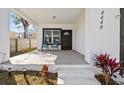 Inviting front porch with seating and a well manicured garden, perfect for relaxation and curb appeal at 4440 58Th N Ave, St Petersburg, FL 33714