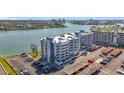 Aerial view showcasing condo buildings next to the water with a parking area at 500 Treasure Island Cswy # 207, Treasure Island, FL 33706