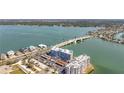 Aerial view showcasing condo buildings next to the water, featuring a nearby bridge at 500 Treasure Island Cswy # 207, Treasure Island, FL 33706