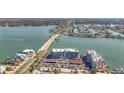 Aerial view showcasing condo buildings next to the water, featuring a nearby bridge and roadways at 500 Treasure Island Cswy # 207, Treasure Island, FL 33706