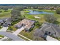 An elevated view of a single-story home with a tile roof, located on a golf course community at 5021 Championship Cup Ln, Spring Hill, FL 34609