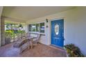 Cozy front porch with seating, an oval blue door, and decorative features for relaxing at 8940 Park Blvd # 8940A, Seminole, FL 33777