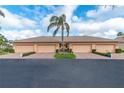 The building's exterior features an attached garage, lovely landscaping, and a well-maintained brick driveway at 9808 62Nd N Ter # 9808, St Petersburg, FL 33708