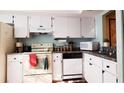 Functional kitchen featuring white cabinetry, and essential appliances at 11204 Pembridge Ct # 5, Port Richey, FL 34668