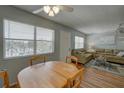 Cozy living and dining space with a large window, ceiling fan, and comfortable seating at 11620 Park Blvd # 308, Seminole, FL 33772