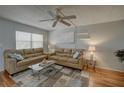 Inviting living room features two sofas, a ceiling fan, and a large window for natural light at 11620 Park Blvd # 308, Seminole, FL 33772