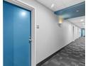 Hallway with decorative lighting and neutral decor leading to unit 909 at 1208 E Kennedy Blvd # 1019, Tampa, FL 33602