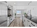 Modern kitchen with stainless steel appliances and an adjacent living area with a large window at 1208 E Kennedy Blvd # 1019, Tampa, FL 33602