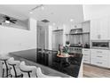 Bright kitchen features black granite counters, stainless steel appliances, and modern white cabinetry at 1208 E Kennedy Blvd # 1019, Tampa, FL 33602