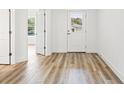 Bright hallway with white walls and doors and wood-look floors at 13065 Tinamou Ave, Weeki Wachee, FL 34614