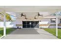 View of ceiling fans under the carport, attached to the front of the garage at 1369 Whitacre Dr, Clearwater, FL 33764