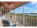 Relaxing screened patio with chairs offering scenic views of the lush landscape and bay at 14584 El Paseo Dr, Seminole, FL 33776