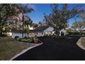 Beautiful single-story home featuring a well-manicured lawn and circular driveway at 19242 Blount Rd, Lutz, FL 33558