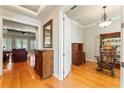 Inviting foyer displaying gleaming hardwood floors, classic wood furniture, and views into the living area at 2209 Branch Hill St, Tampa, FL 33612